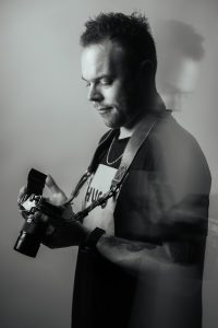 Eran with a Canon AE1 film camera